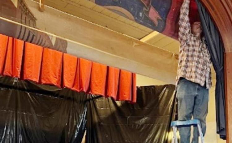 Terry Brewer working on the proscenium curtain