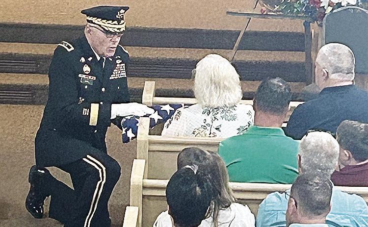 National Guard Major General (Ret.) Charles “Jim” Barr presented a folded U.S. flag to the family of Marvin Behrends, World War II veteran of the 80th Infantry Division, US Army, who died this past year.