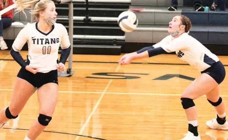 HTRS’ Natalie Novak (right) sets the ball up while hitter Katilyn Glathar (#11, left) tries to get in position to hit in the Class D1-1 subdistricts last week. photo courtesy of Lorrie Novak