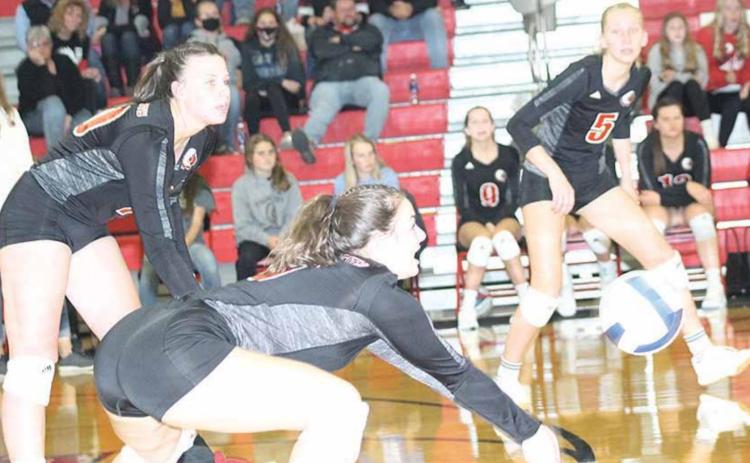 P.C.’s Larissa Tegtmeier (#6) bumps a ball to the front row as teammates Austin Branch (left) and Sierra deKoning (#5, right) look to help. Paula Jasa/Republican