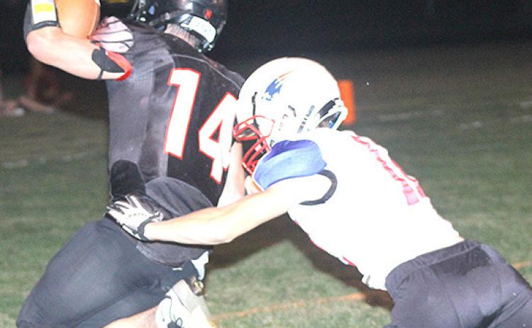 P.C.’s Jett Farwell (#14) eludes a Parkview Christian tackler on his way to the end zone Friday night. Farwell scored all three of Pawnee City’s touchdowns. Paula Jasa/Republican