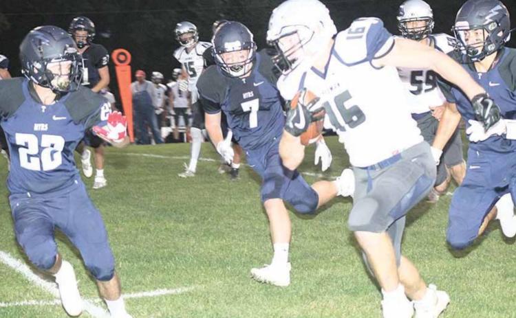 HTRS’ Rob Mather (#22, left), Josh Bachman (#12) and Donovan Kostecka try to run down Freeman’s quarterback Holden Ruse (#16) in Friday night action. Paula Jasa/Republican