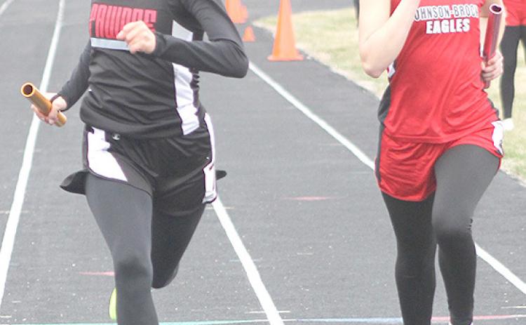 Paula Jasa/Republican P.C.’s Emily Lytle (left) passes a Johnson-Brock runner at the end of the 1600 M. Relay to win with a time of 4:37.08.