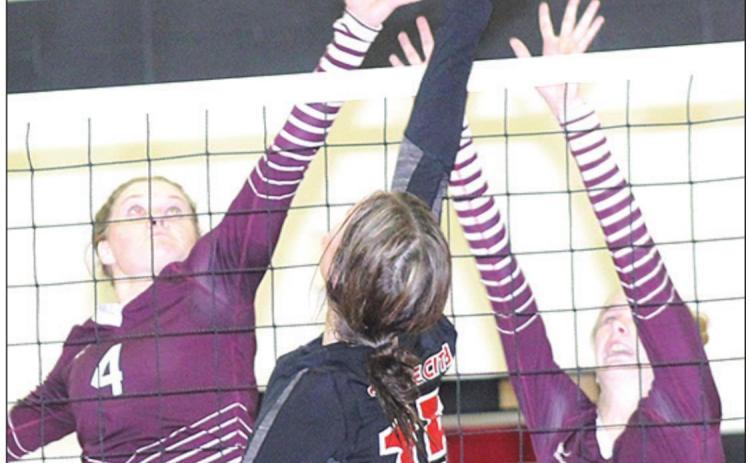 P.C.’s Logan Maloley (#15, center) goes up at the net against Lewiston’s Emma deKoning (#4, left) and Katelyn Sanders (#3, right). Paula Jasa/Republican