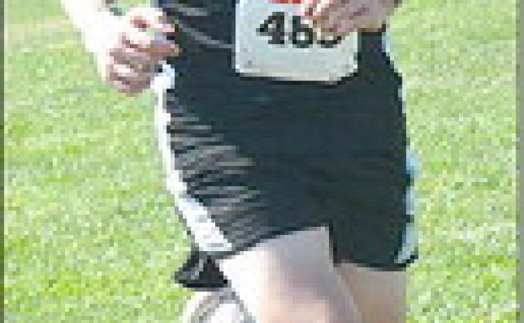 Pawnee City’s Cael Johnson (left) strides up the hill at the Johnson County Central Cross Country Invitational which was held on Friday, September 1st. Cael tied for 40th place at the meet. Photo courtesy of Heidi Koster